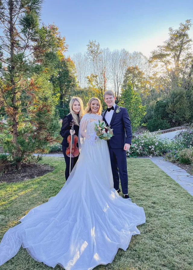 Wedding with cathedral-train gown in fall foliage garden in golden-hour light